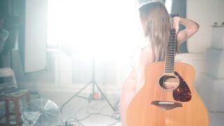 girl posing naked with a guitar (music)